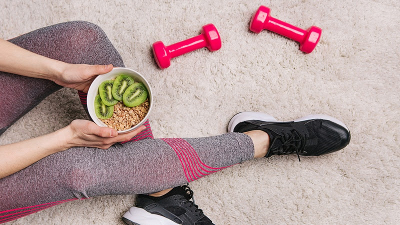 girl sporting elk plate muesli kiwi fitness workout dumbbells